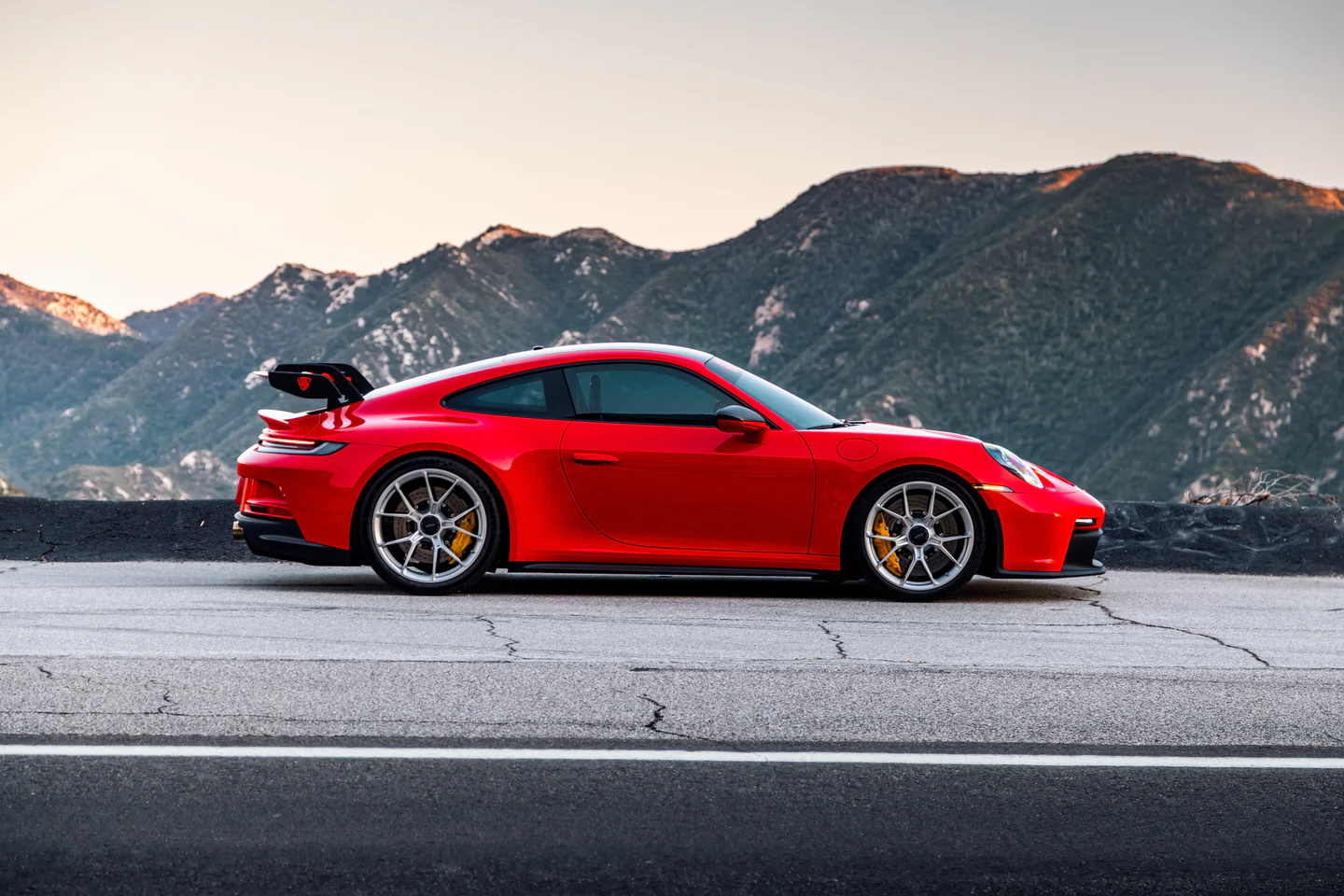 Red Porsche 911 GT3 with mountains behind
