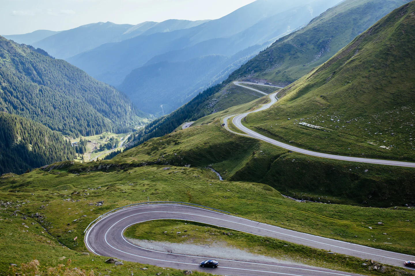 Winding Alpine pass through green valleys