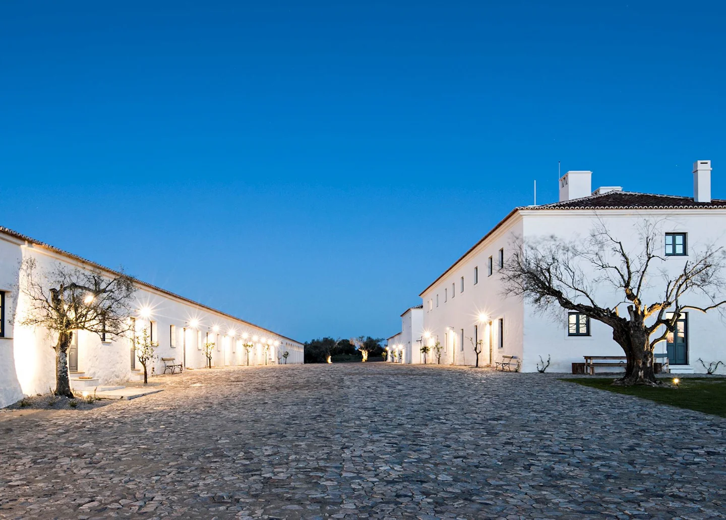 Whitewashed hotel buildings at dusk