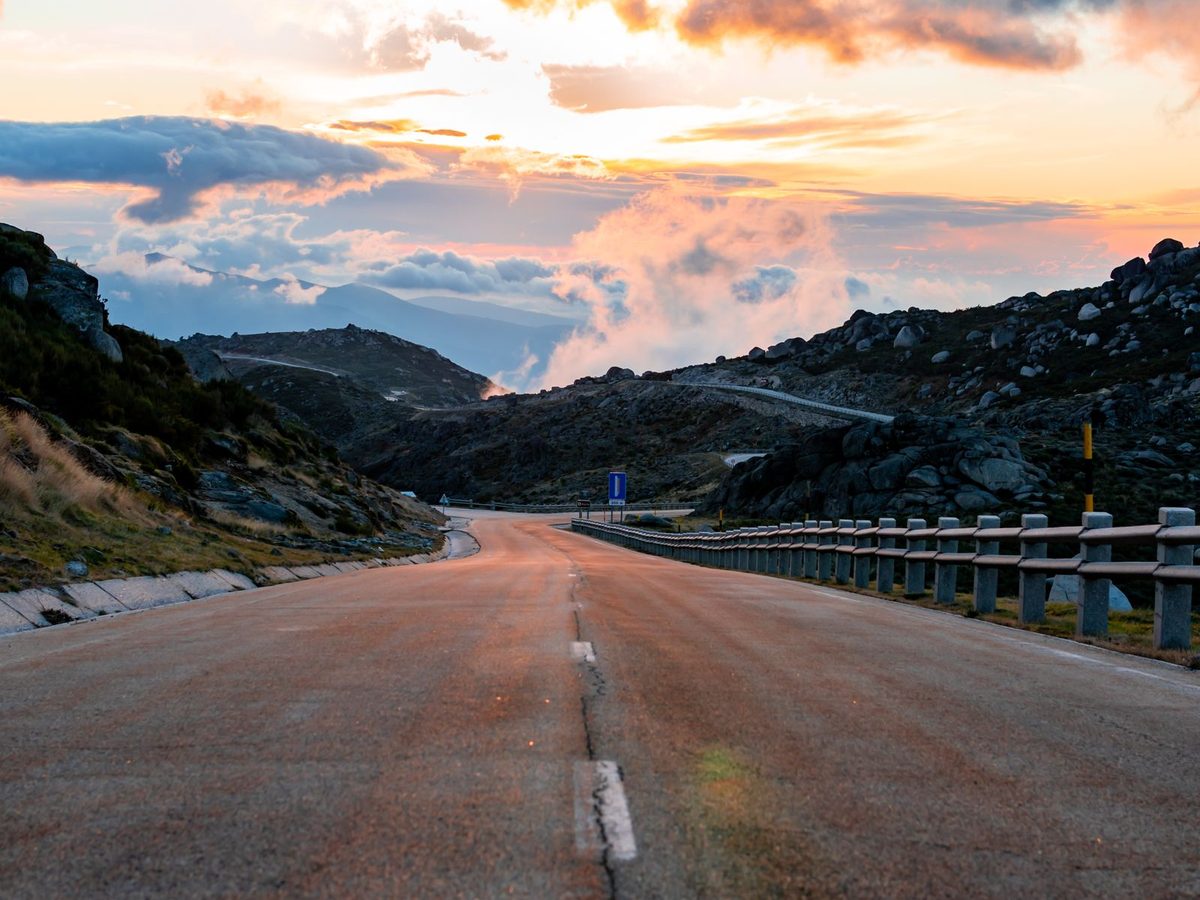 An empty mountain road on the Serra da Estrela plateau at sunset